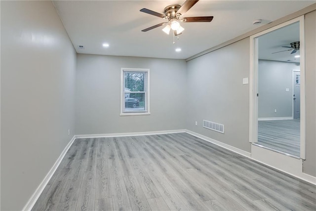 unfurnished room with ceiling fan and light hardwood / wood-style flooring