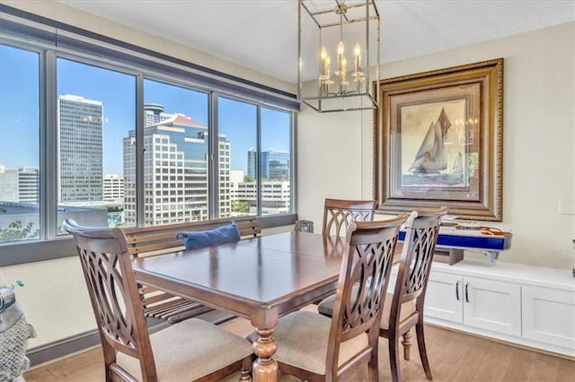 dining room featuring light hardwood / wood-style floors and a notable chandelier