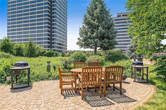 view of patio featuring outdoor dining area, fence, and grilling area