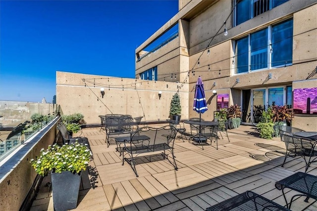 wooden terrace with outdoor dining area