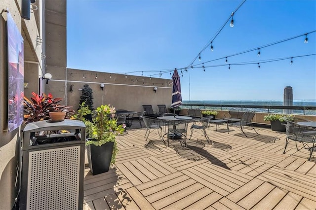 wooden deck with outdoor dining area and grilling area