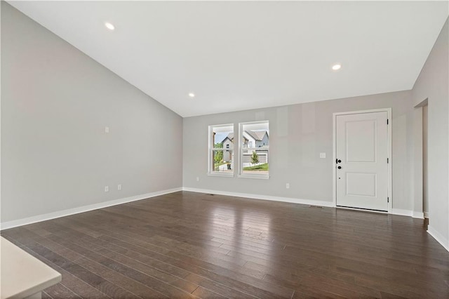 unfurnished living room with lofted ceiling and dark wood-type flooring