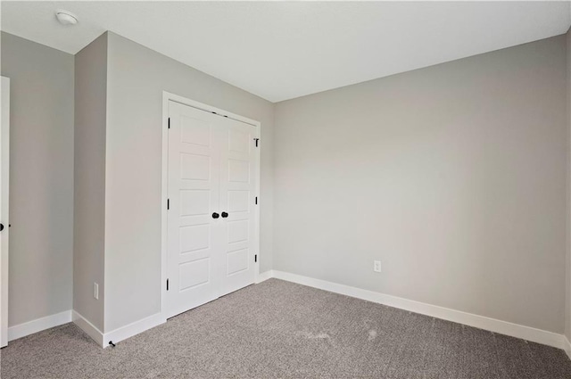 unfurnished bedroom with carpet flooring and a closet