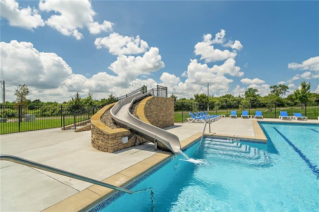 view of swimming pool featuring a water slide and a patio