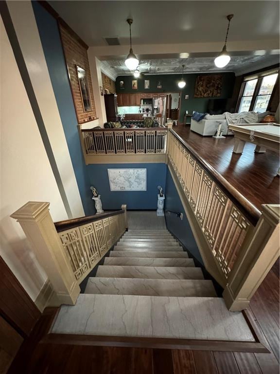 staircase featuring wood-type flooring