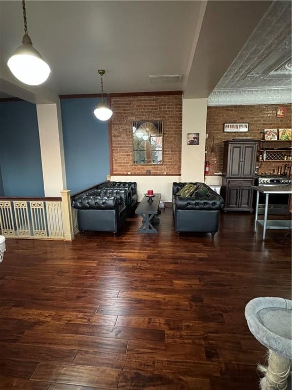 interior space featuring dark wood-type flooring and brick wall