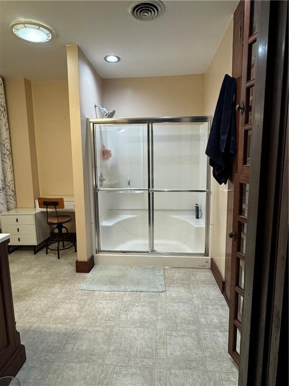 bathroom featuring vanity and an enclosed shower