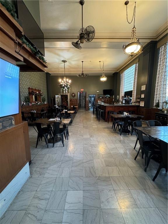 dining area featuring a chandelier and crown molding