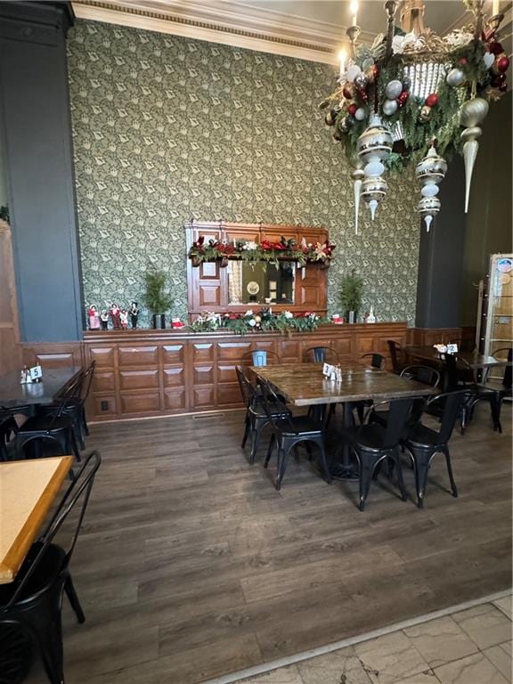 dining space with hardwood / wood-style flooring and ornamental molding