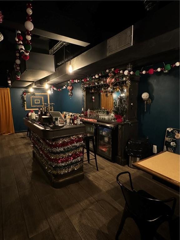 bar with wood-type flooring and wine cooler