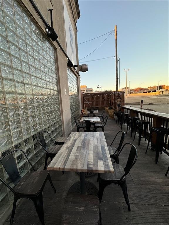 patio terrace at dusk featuring an outdoor bar