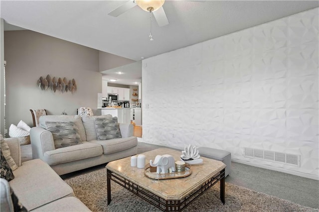 living room featuring carpet flooring and ceiling fan