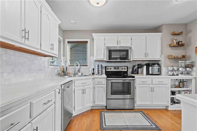 kitchen featuring white cabinetry, sink, and stainless steel appliances