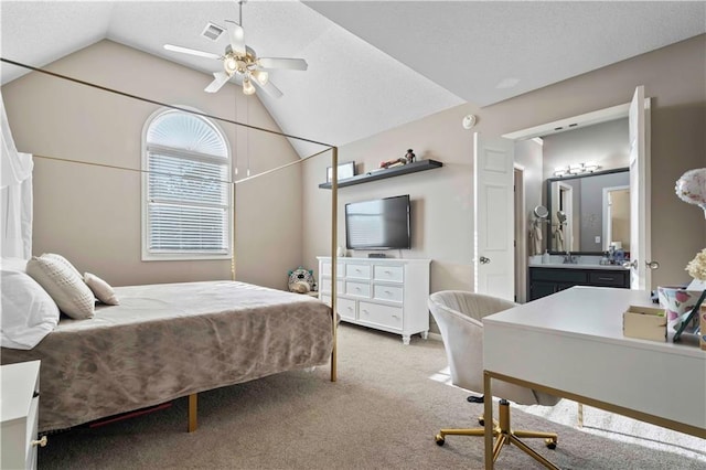 carpeted bedroom with ceiling fan, sink, and lofted ceiling