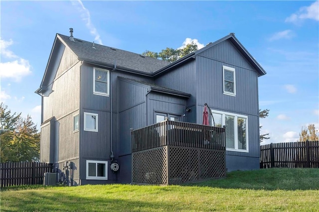 back of house featuring a lawn, central AC, and a deck