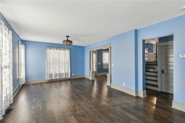 unfurnished room with dark hardwood / wood-style flooring