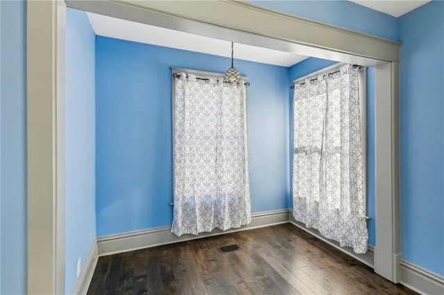 spare room featuring dark hardwood / wood-style floors