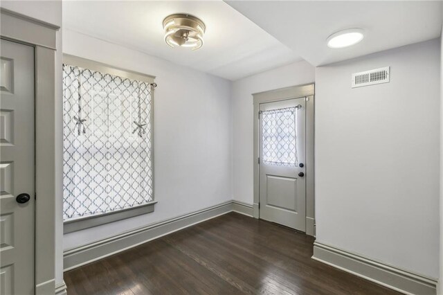 entrance foyer with dark hardwood / wood-style floors