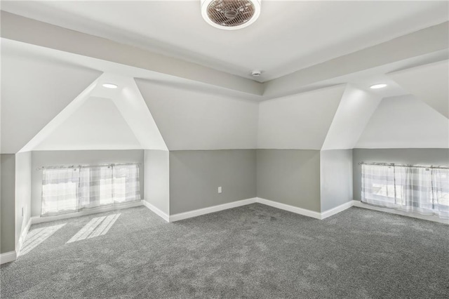 additional living space featuring lofted ceiling and carpet flooring