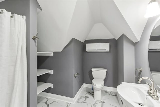 bathroom featuring toilet, lofted ceiling, an AC wall unit, and sink