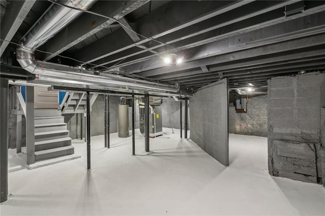 basement featuring heating unit and water heater