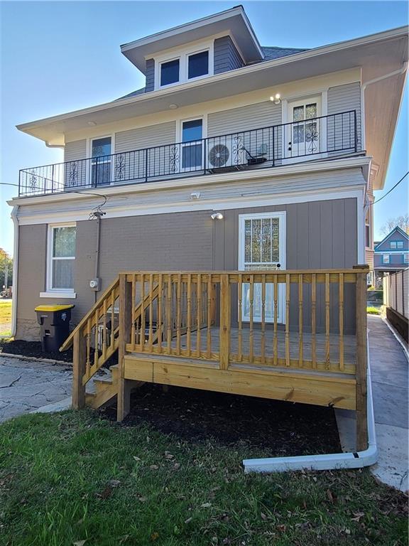 rear view of property with a balcony