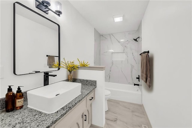 full bathroom with vanity, tiled shower / bath combo, and toilet