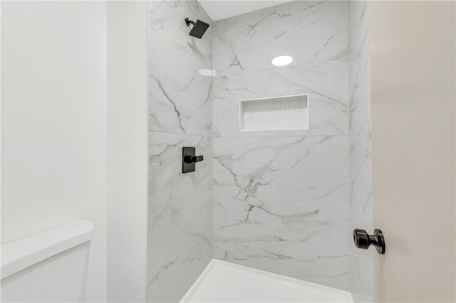 bathroom with a tile shower