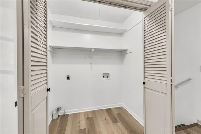 washroom featuring washer hookup, light hardwood / wood-style flooring, and electric dryer hookup