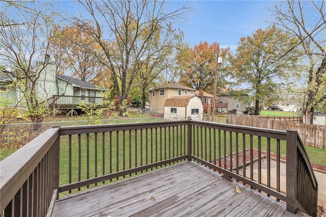 wooden deck with a yard and a shed