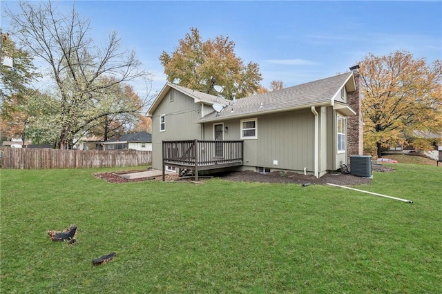 back of house with a yard, a deck, and central AC unit