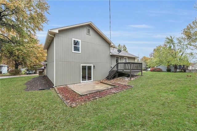 back of property featuring a yard, a deck, and a patio area