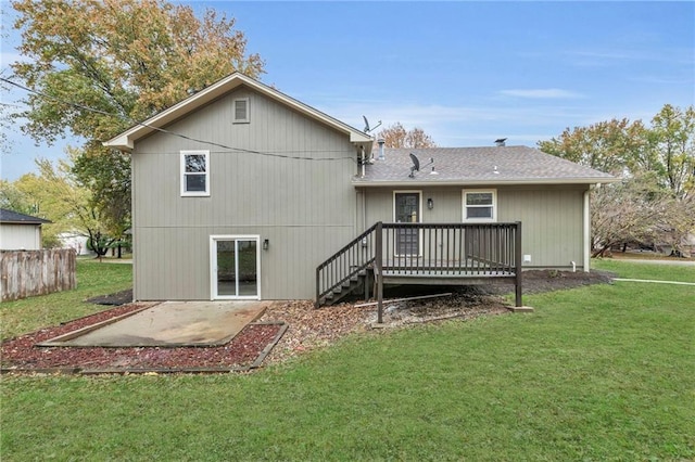 rear view of property with a yard, a patio, and a deck