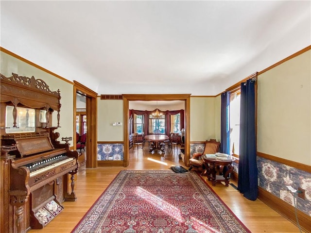 living area featuring light hardwood / wood-style floors and an inviting chandelier