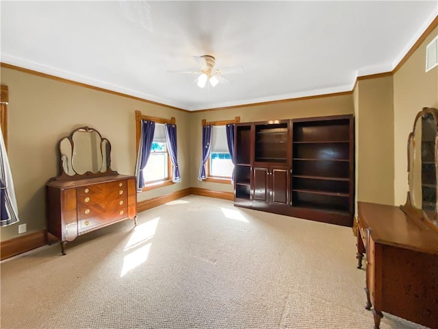 living room with ceiling fan, ornamental molding, and light carpet