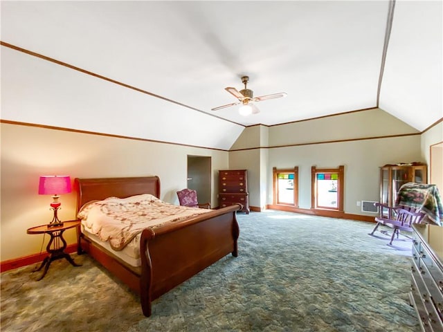 carpeted bedroom with ceiling fan and vaulted ceiling