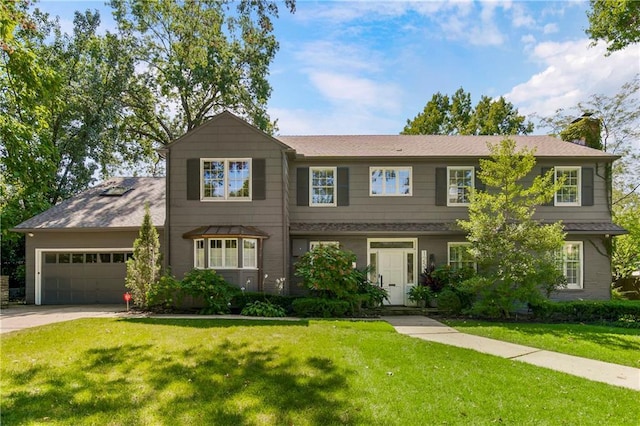 view of front of property with a garage and a front lawn