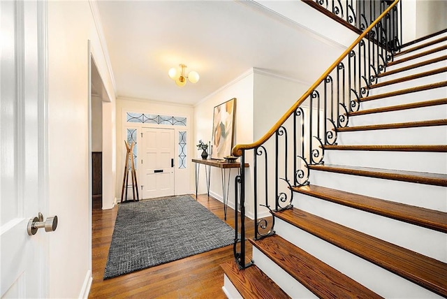 entryway featuring dark hardwood / wood-style floors and ornamental molding