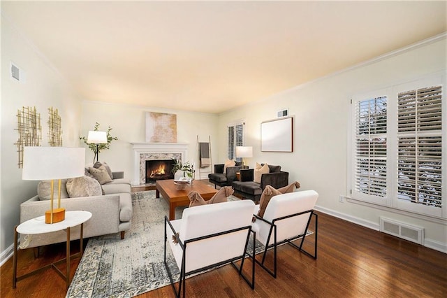 living room with dark hardwood / wood-style floors and ornamental molding