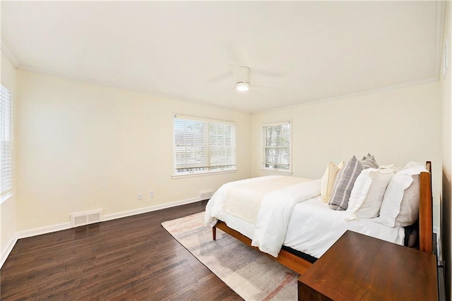 bedroom featuring ornamental molding, ceiling fan, and dark wood-type flooring