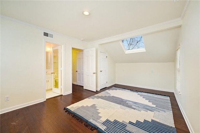 additional living space with lofted ceiling with skylight and dark hardwood / wood-style floors