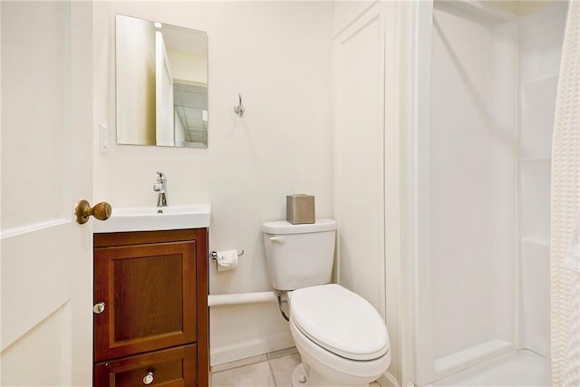 bathroom featuring tile patterned floors, vanity, and toilet