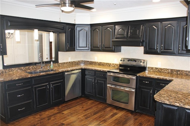 kitchen with dark wood-type flooring, sink, dark stone countertops, ornamental molding, and stainless steel appliances