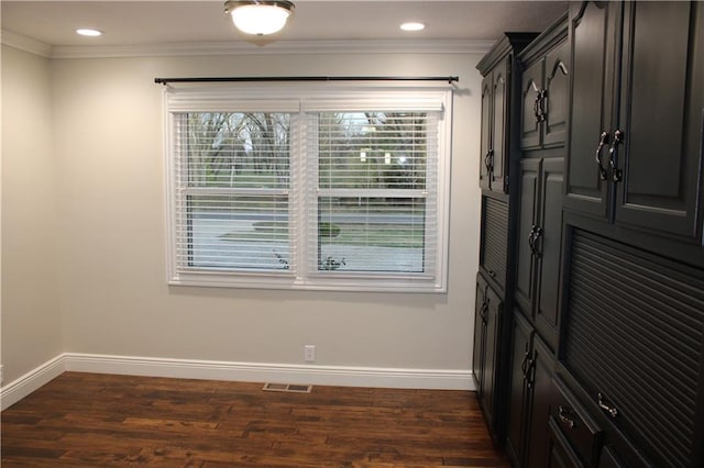 interior space featuring crown molding and dark wood-type flooring