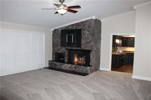 unfurnished living room with crown molding, a fireplace, carpet flooring, and vaulted ceiling