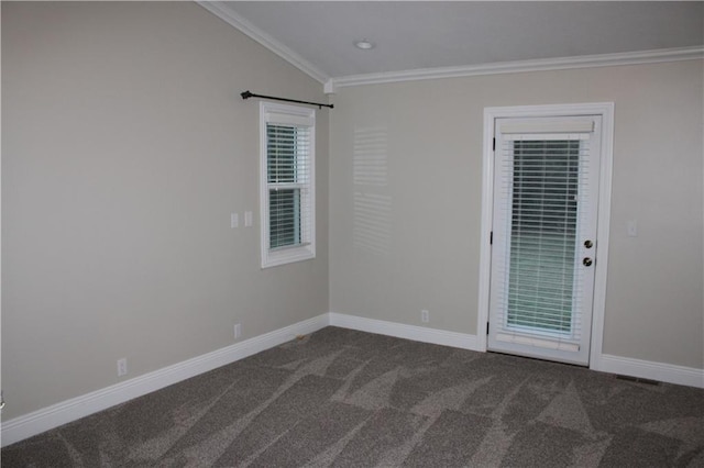 spare room with crown molding, dark carpet, and vaulted ceiling