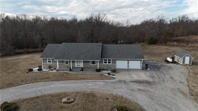 view of front of house featuring a garage, a front lawn, and covered porch