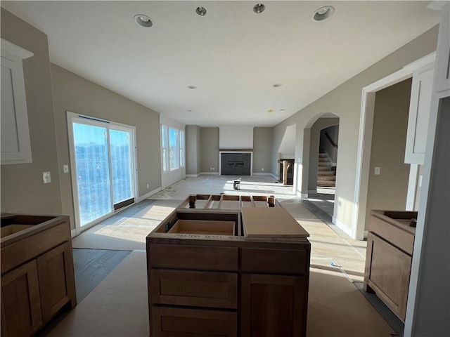 kitchen with light wood-type flooring, white cabinets, and a kitchen island