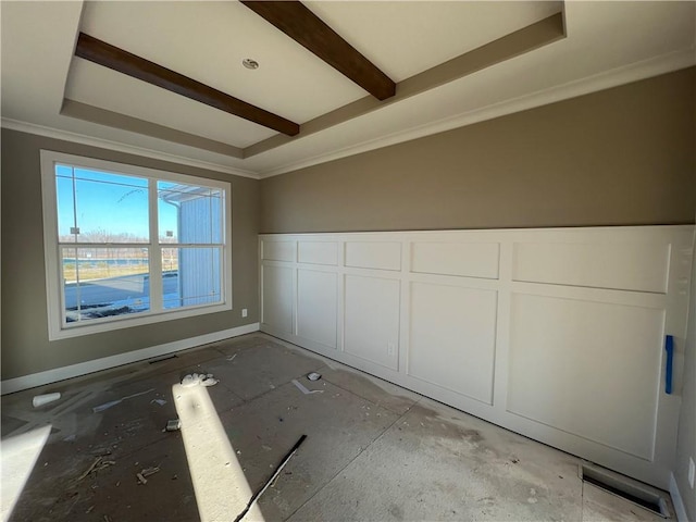 empty room with ornamental molding and beamed ceiling