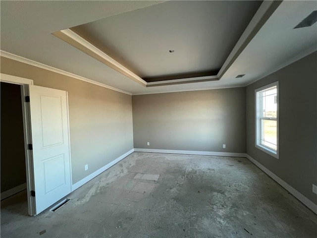 unfurnished room with a raised ceiling